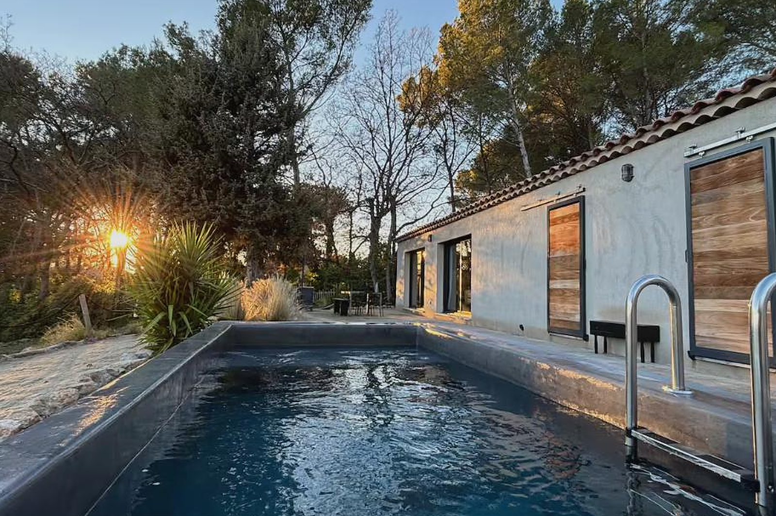 La piscine de Casa Papey au coucher du soleil, entre les pins